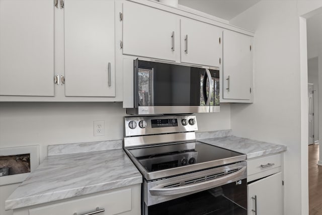 kitchen with white cabinetry and appliances with stainless steel finishes