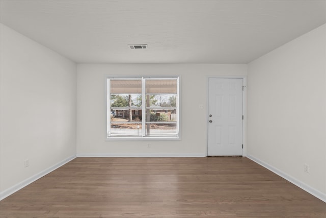 spare room with wood-type flooring