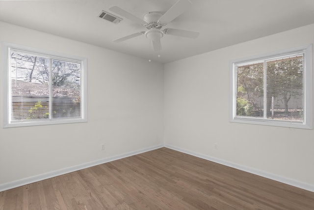 spare room with hardwood / wood-style flooring and ceiling fan