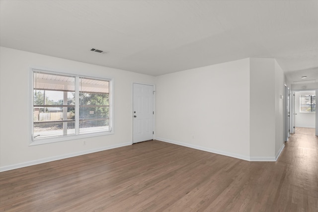 unfurnished room with hardwood / wood-style floors