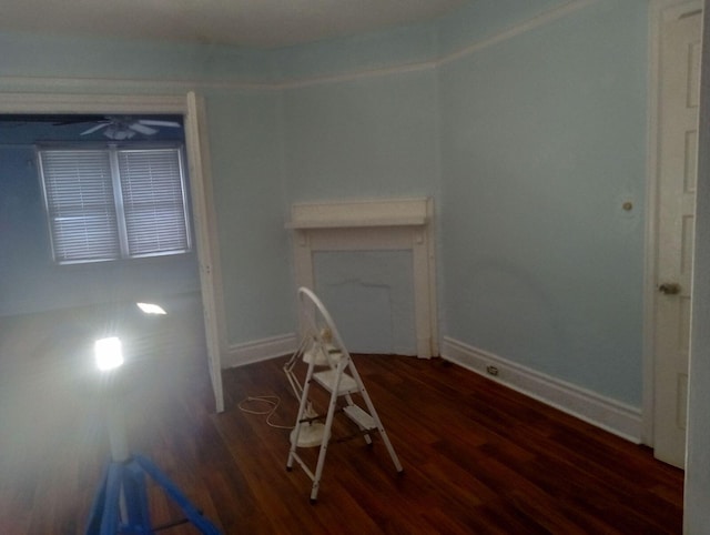 interior space with ceiling fan and dark wood-type flooring