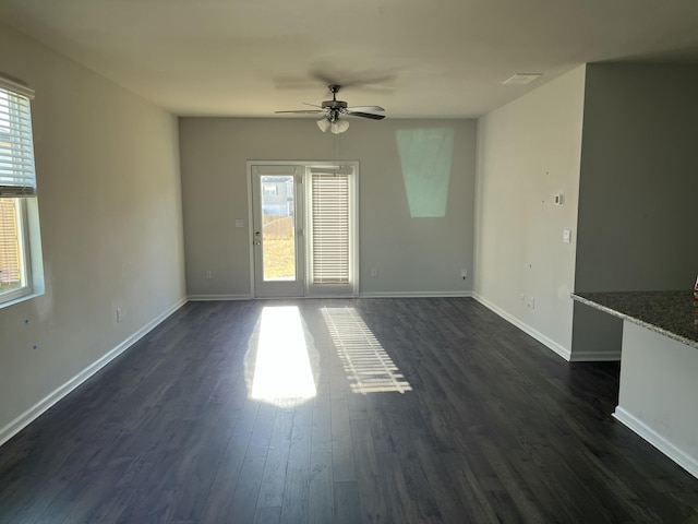 unfurnished living room with ceiling fan and dark hardwood / wood-style flooring