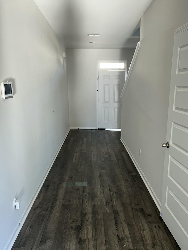 hall with dark wood-type flooring