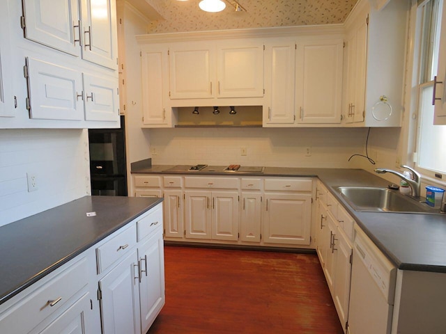 kitchen featuring white dishwasher, sink, white cabinetry, and dark wood-type flooring