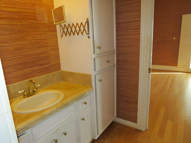 bathroom featuring hardwood / wood-style flooring and vanity