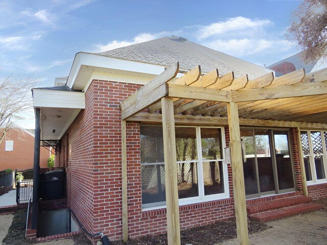 view of side of home with a pergola