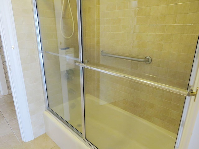 bathroom featuring tile patterned floors and enclosed tub / shower combo