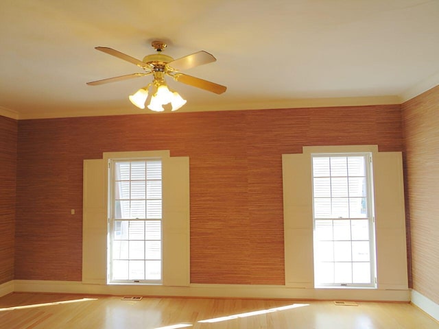 spare room featuring hardwood / wood-style flooring and ceiling fan