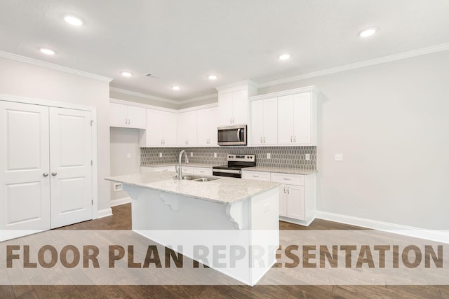 kitchen with appliances with stainless steel finishes, sink, white cabinetry, and an island with sink