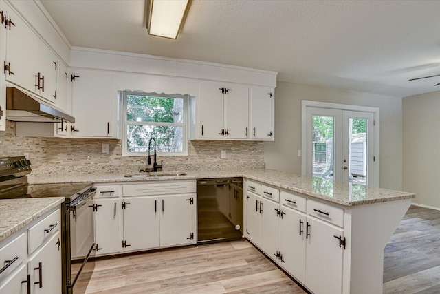 kitchen with kitchen peninsula, sink, white cabinetry, and black appliances