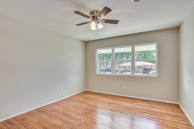 spare room with light hardwood / wood-style floors and ceiling fan