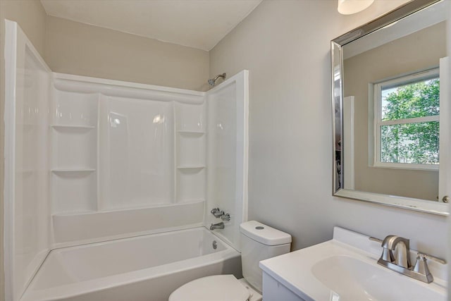 full bathroom featuring vanity, bathtub / shower combination, and toilet