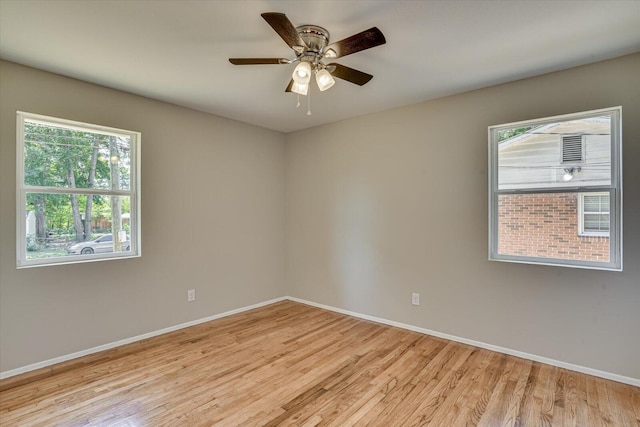 unfurnished room with light wood-type flooring and ceiling fan