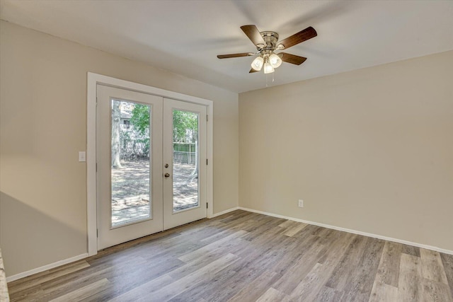 entryway featuring ceiling fan, french doors, and light hardwood / wood-style floors