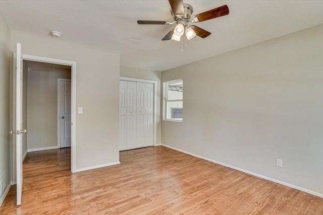 unfurnished bedroom featuring ceiling fan, light hardwood / wood-style floors, and a closet