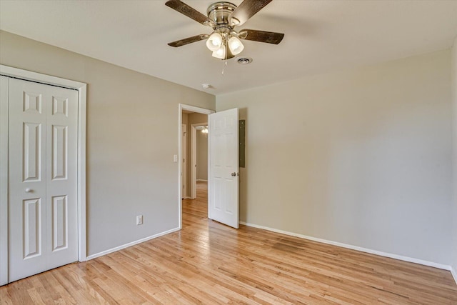 unfurnished bedroom with light wood-type flooring, a closet, and ceiling fan