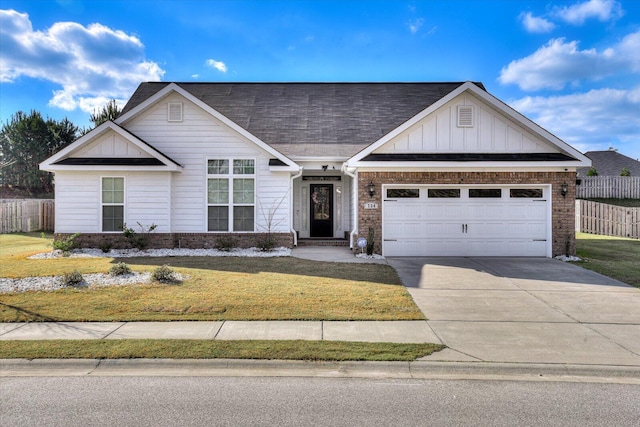 view of front of property featuring a front yard and a garage