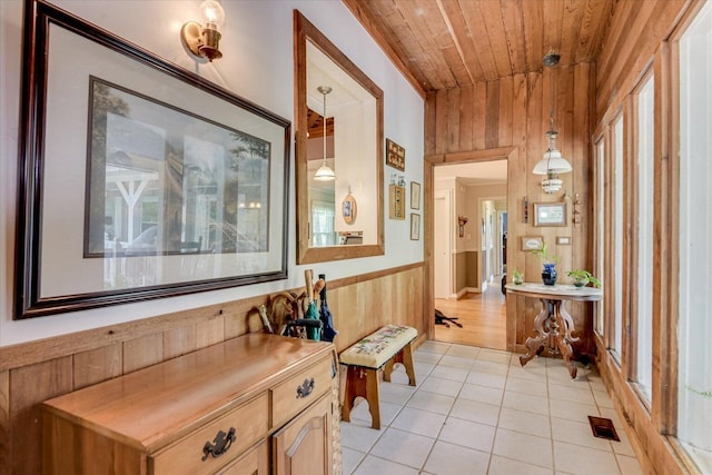 889 Woodhaven St, North, SC 29112 - corridor featuring wood ceiling, wooden walls, light tile patterned floors, and wainscoting