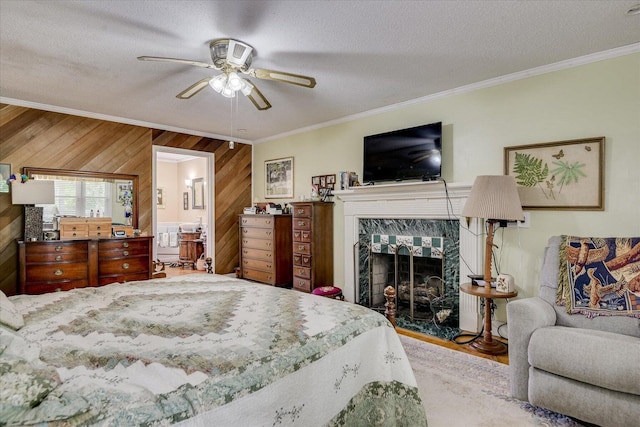 889 Woodhaven St, North, SC 29112 - bedroom featuring crown molding, wood walls, a fireplace, a textured ceiling, and wood finished floors