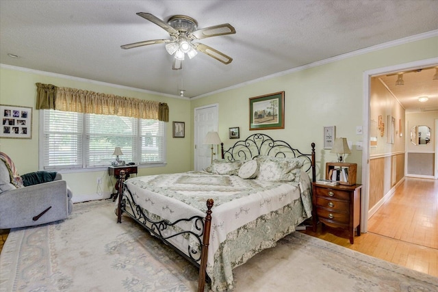 889 Woodhaven St, North, SC 29112 - bedroom with wood-type flooring, a textured ceiling, ornamental molding, and ceiling fan