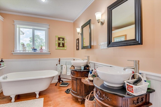 889 Woodhaven St, North, SC 29112 - bathroom featuring a wainscoted wall, wood finished floors, crown molding, a soaking tub, and vanity