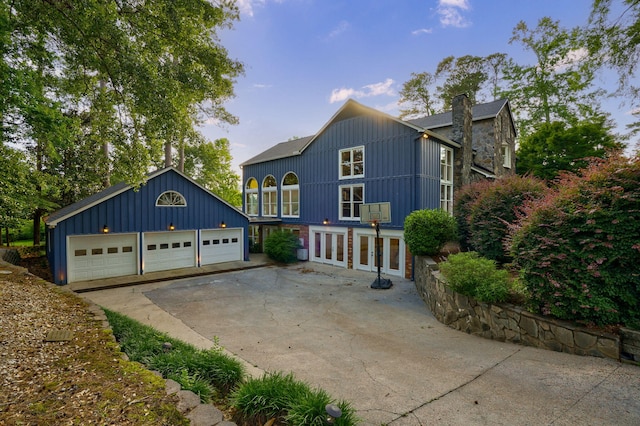 3507 Lost Tree Ln, Martinez, GA 30907 - view of front of property with french doors, a garage, board and batten siding, an outbuilding, and a chimney