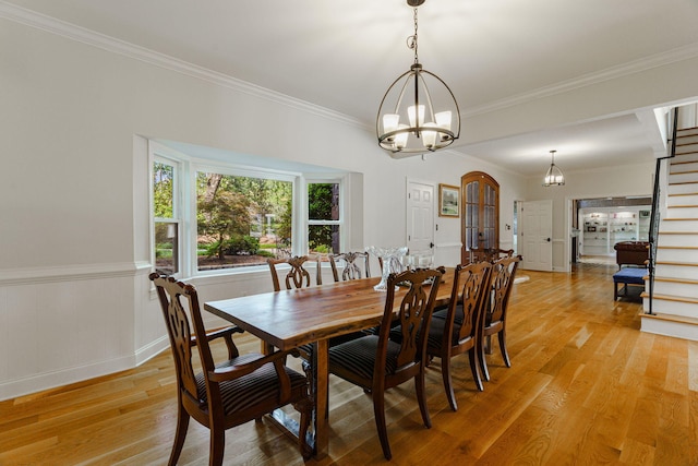 3507 Lost Tree Ln, Martinez, GA 30907 - dining space featuring a chandelier, light wood-type flooring, stairway, crown molding, and a wainscoted wall