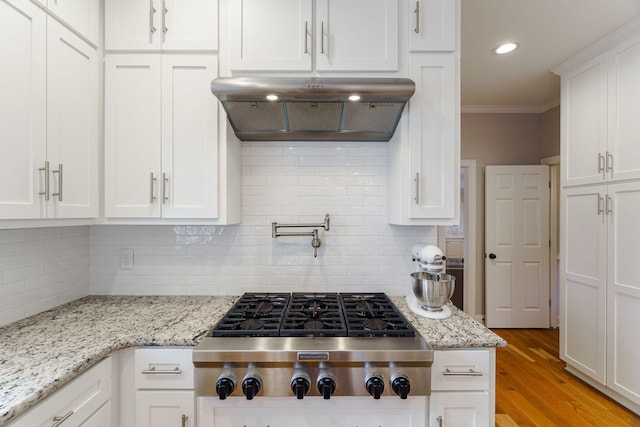 3507 Lost Tree Ln, Martinez, GA 30907 - kitchen with stainless steel gas cooktop, under cabinet range hood, white cabinets, crown molding, and tasteful backsplash