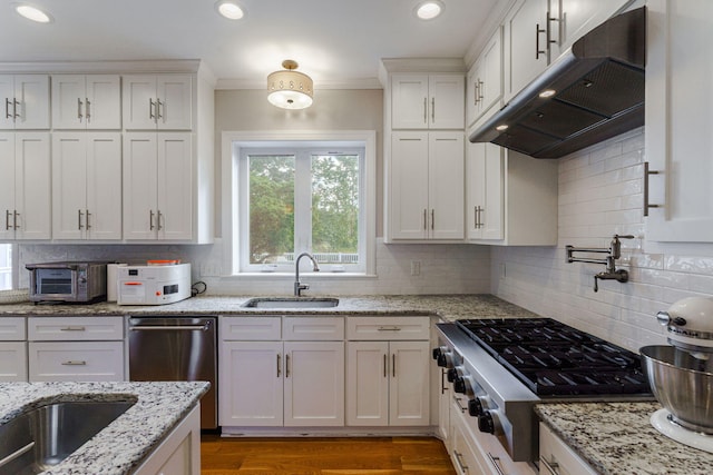 3507 Lost Tree Ln, Martinez, GA 30907 - kitchen featuring a sink, under cabinet range hood, appliances with stainless steel finishes, white cabinets, and ornamental molding