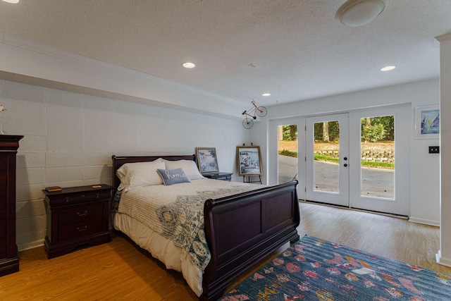 3507 Lost Tree Ln, Martinez, GA 30907 - bedroom with light wood-style flooring, french doors, access to outside, a textured ceiling, and recessed lighting