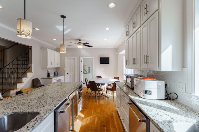 3507 Lost Tree Ln, Martinez, GA 30907 - kitchen with crown molding, dishwasher, light wood finished floors, white cabinets, and tasteful backsplash