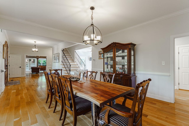 3507 Lost Tree Ln, Martinez, GA 30907 - dining space featuring a chandelier, light wood-type flooring, crown molding, stairs, and wainscoting