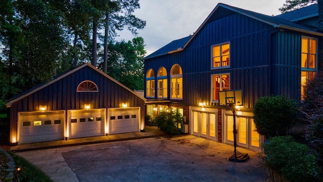 3507 Lost Tree Ln, Martinez, GA 30907 - view of front of house with board and batten siding, driveway, an outbuilding, a garage, and french doors