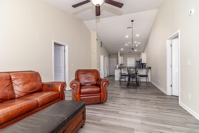 2697 York Dr, Augusta, GA 30909 - living room featuring ceiling fan, a chandelier, light wood-style flooring, baseboards, and high vaulted ceiling