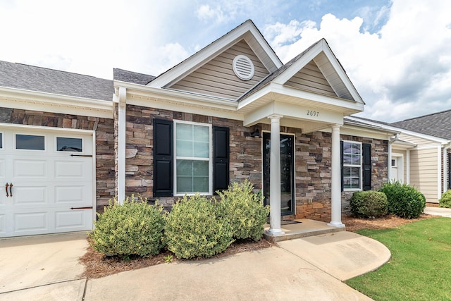 2697 York Dr, Augusta, GA 30909 - entrance to property featuring stone siding, roof with shingles, an attached garage, and concrete driveway