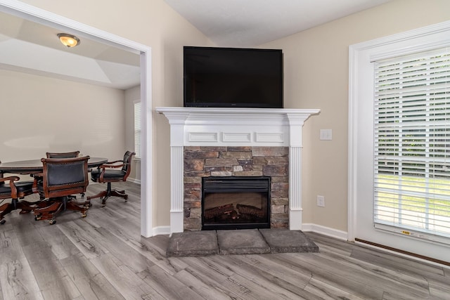 2697 York Dr, Augusta, GA 30909 - living area featuring wood finished floors, a stone fireplace, healthy amount of natural light, and baseboards