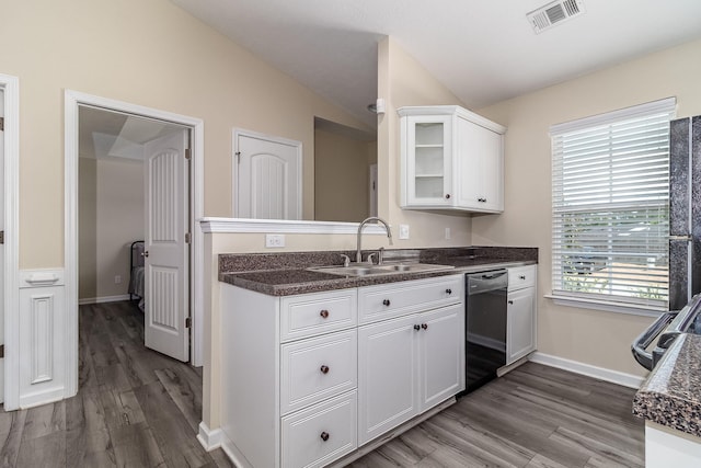 2697 York Dr, Augusta, GA 30909 - kitchen featuring dishwashing machine, a sink, white cabinets, dark countertops, and vaulted ceiling