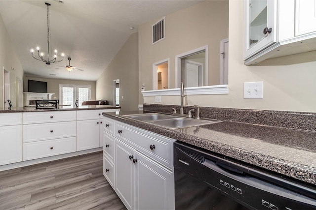 2697 York Dr, Augusta, GA 30909 - kitchen with black dishwasher, a sink, dark countertops, a chandelier, and vaulted ceiling