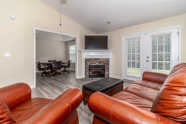 2697 York Dr, Augusta, GA 30909 - living area featuring vaulted ceiling, wood finished floors, baseboards, and a stone fireplace