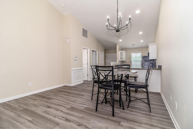 2697 York Dr, Augusta, GA 30909 - dining space featuring a chandelier, wood finished floors, recessed lighting, baseboards, and high vaulted ceiling