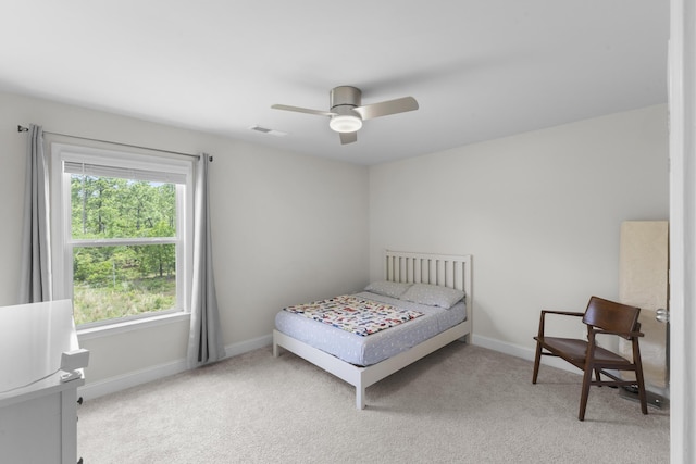 carpeted bedroom with baseboards and ceiling fan