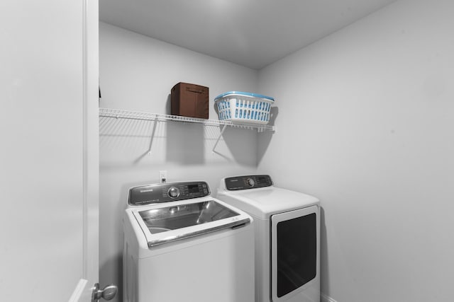 laundry room with washing machine and clothes dryer
