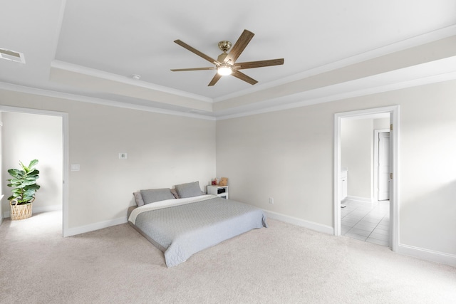 bedroom featuring a tray ceiling, carpet flooring, crown molding, baseboards, and a ceiling fan