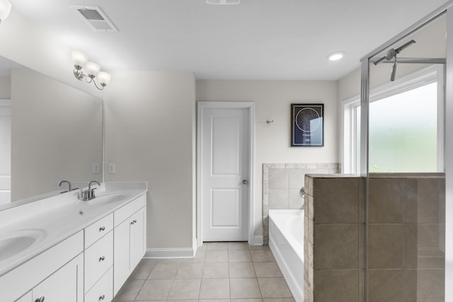 bathroom with tile patterned flooring, a bath, baseboards, and double vanity