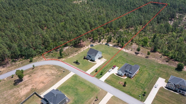 view of property location featuring a forest and property boundaries highlighted