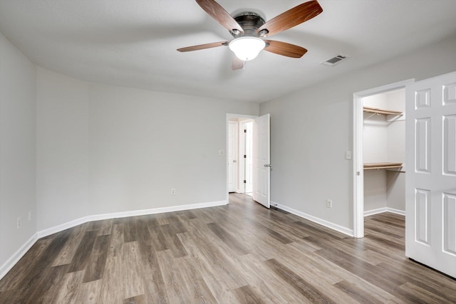 619 Kimberley Pl, Evans, GA 30809 - unfurnished bedroom with wood finished floors, a spacious closet, a closet, and ceiling fan