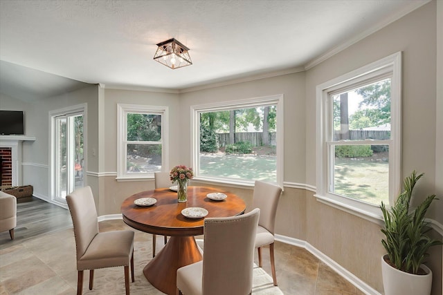 619 Kimberley Pl, Evans, GA 30809 - dining area with plenty of natural light, a fireplace, ornamental molding, and a chandelier
