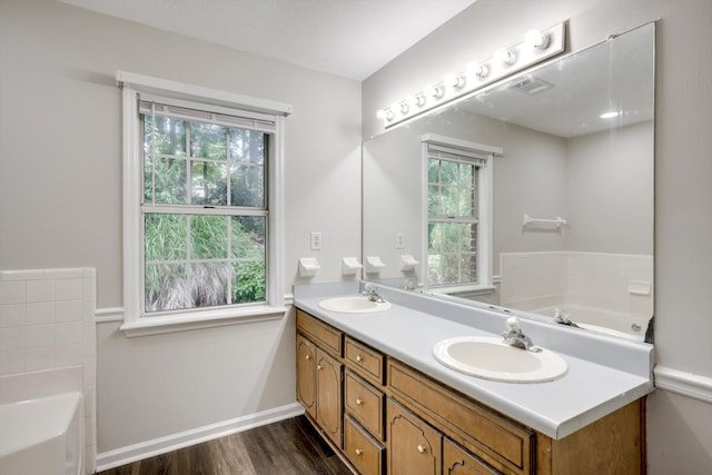 619 Kimberley Pl, Evans, GA 30809 - full bathroom featuring double vanity, a bath, and wood finished floors