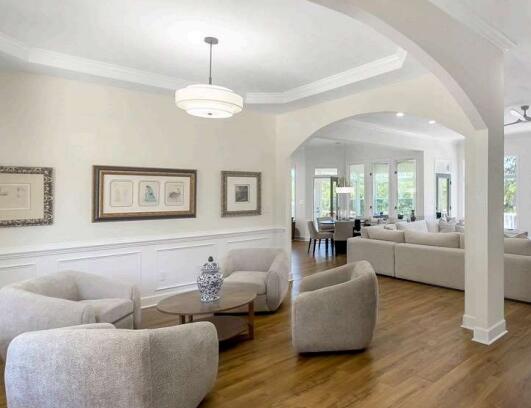 living room with ceiling fan, wood-type flooring, and crown molding