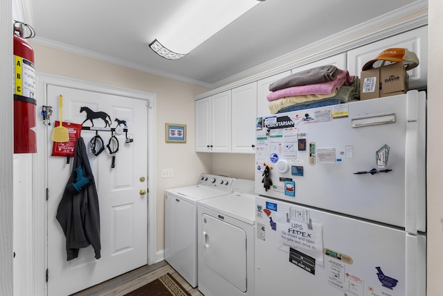 165 Indian Valley Ln, Swansea, SC 29160 - washroom featuring washing machine and clothes dryer, cabinet space, crown molding, and wood finished floors